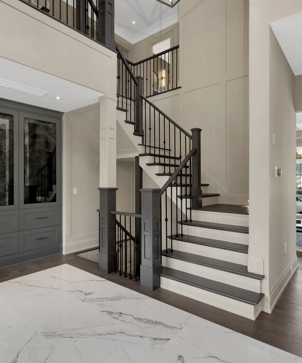 Elegant Transitional Entryway with Custom Staircase & Storage
