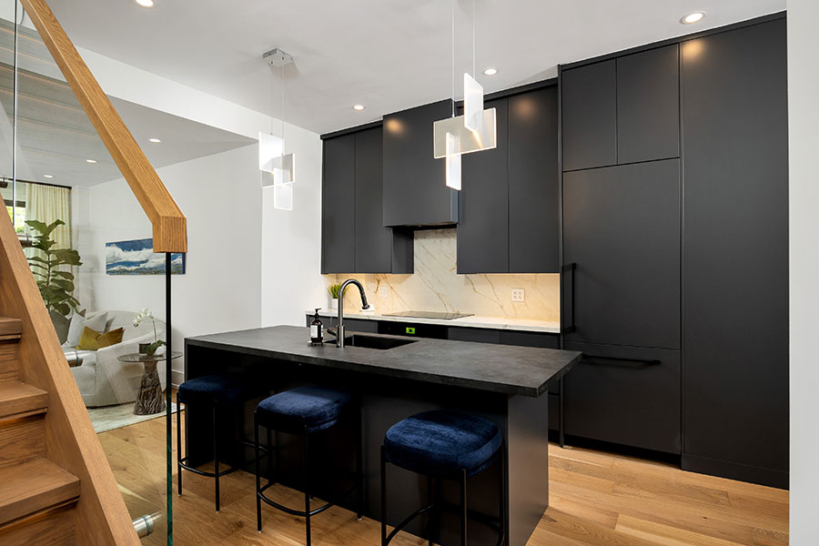 Sleek Modern Kitchen with Black Cabinetry & Marble Backsplash
