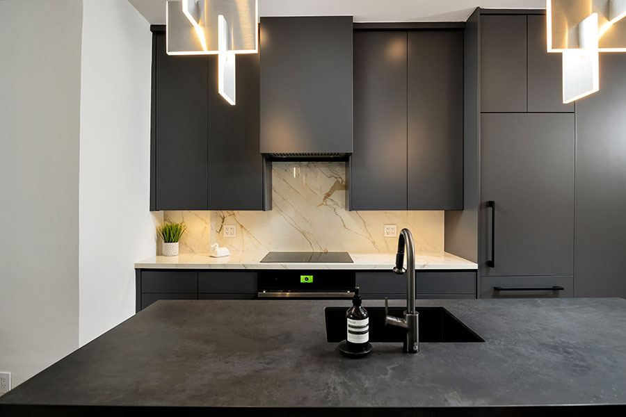 Sleek Modern Kitchen with Dark Cabinetry and Marble Backsplash