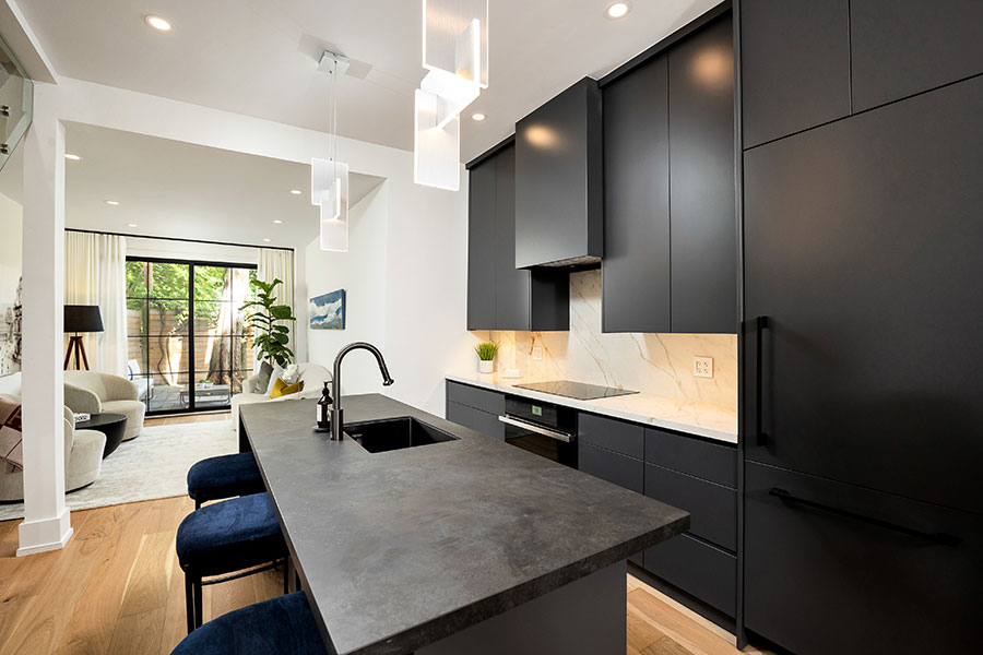 Contemporary Black Kitchen with Marble Backsplash