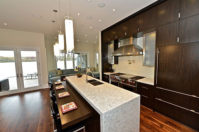 Contemporary Kitchen with Waterfall Island and Dark Wood Cabinets