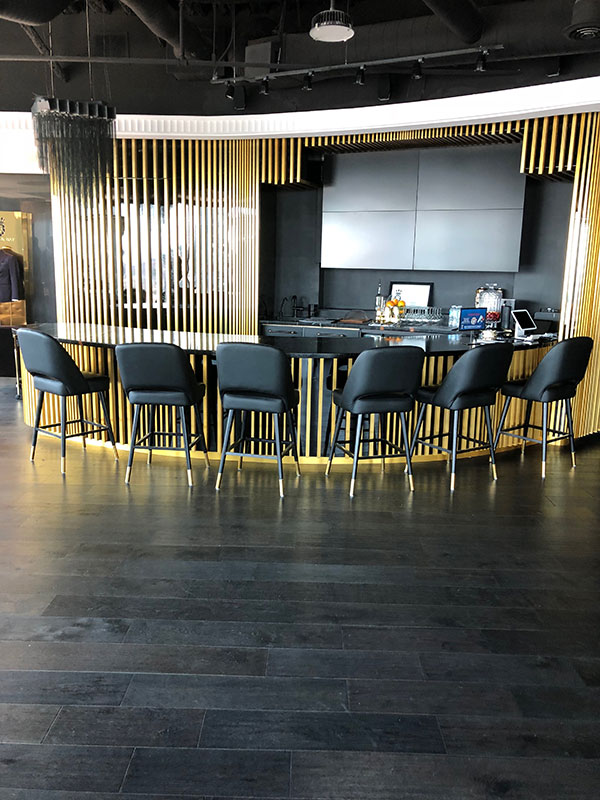 Modern Commercial Bar with Gold Slats and Black Accents