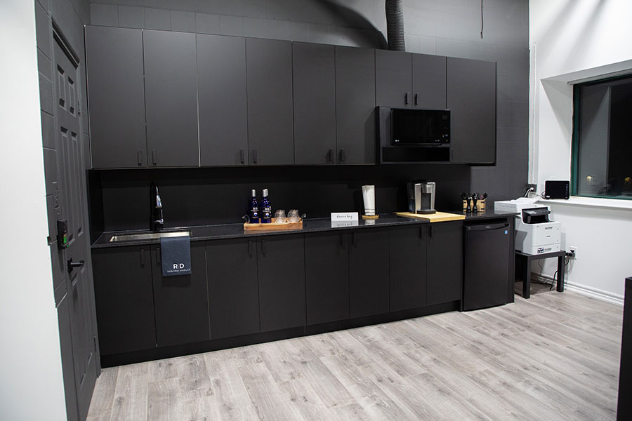 Modern Commercial Kitchenette with Black Cabinetry