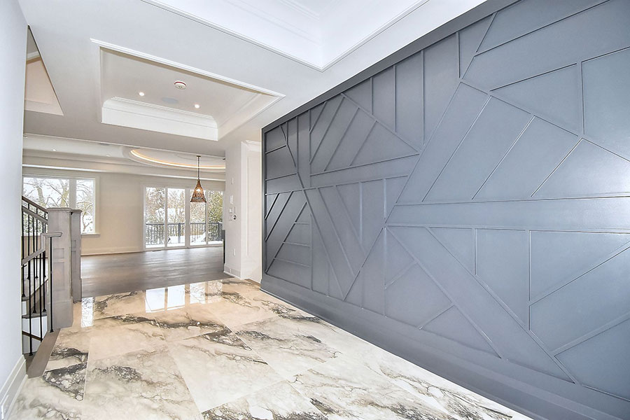 Modern Entryway with Geometric Feature Wall and Marble Tiles