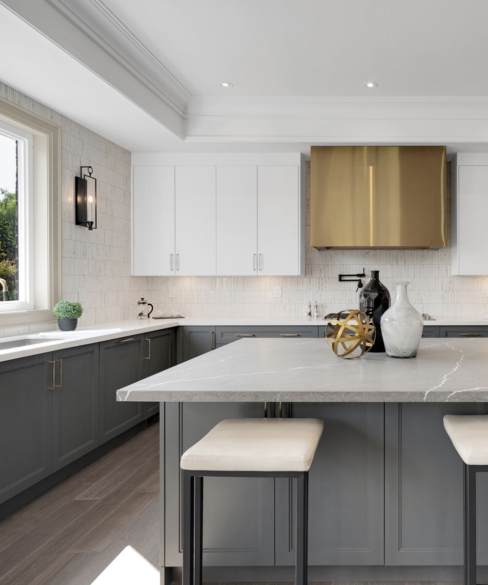 Modern Two-Tone Kitchen with Gold Hood & Quartz Island