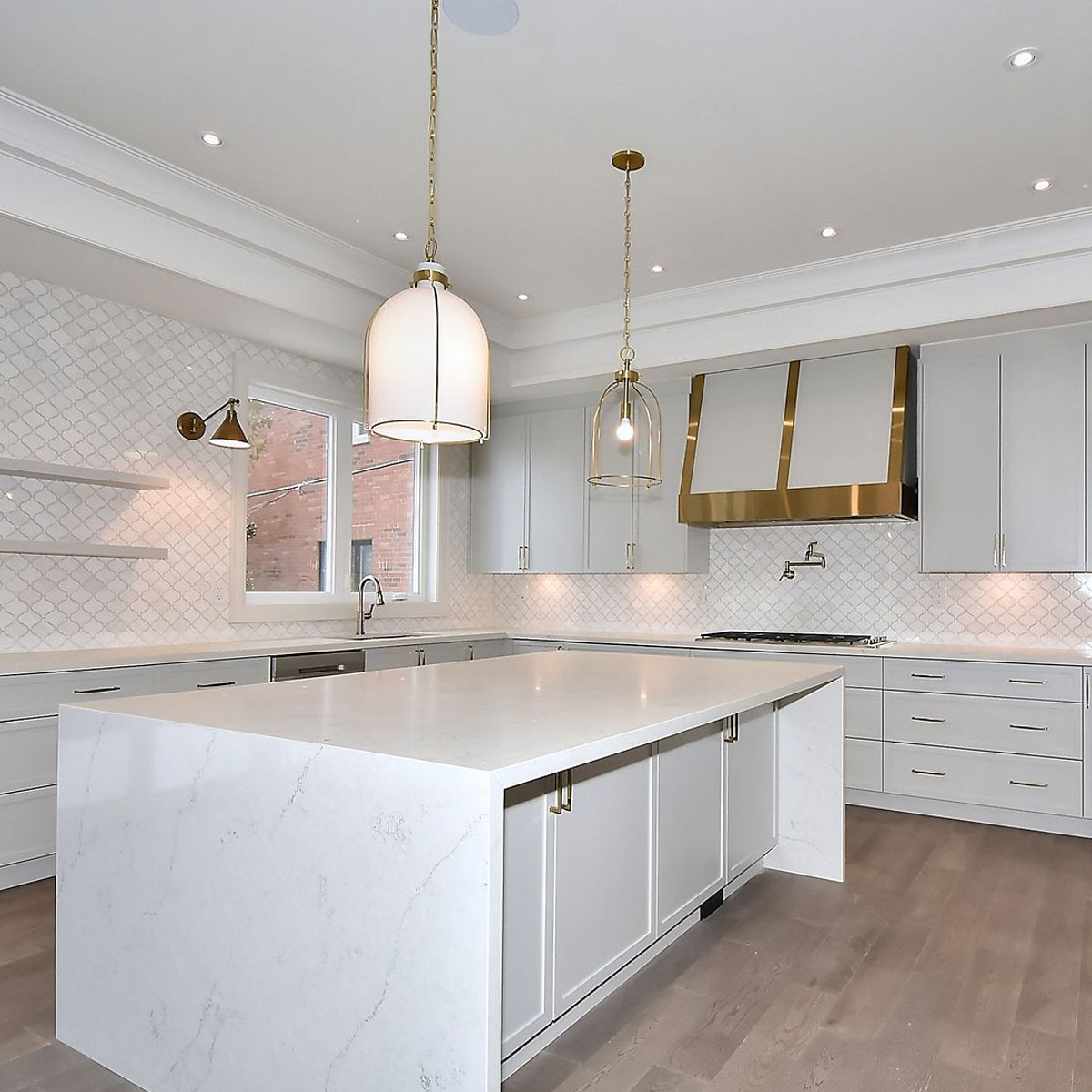 Elegant Transitional Kitchen with White Cabinets and Brass Accents